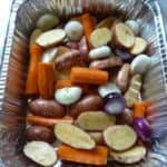 Mixed root vegetables in a foil pan