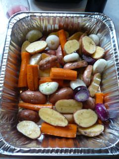 Mixed root vegetables in a foil pan
