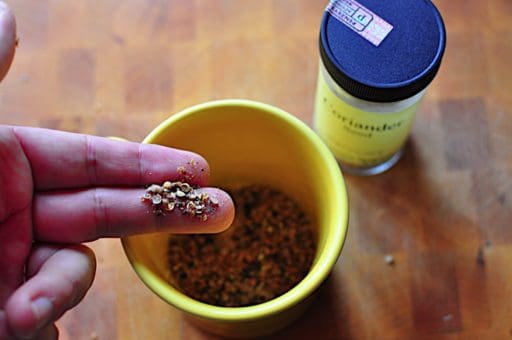 Spices ground in a cup with a spice jar pestle