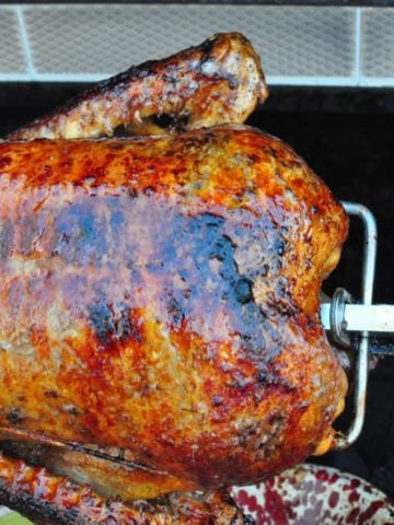 Cooked duck on a rotisserie spit