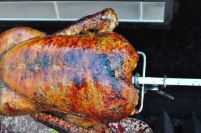 Cooked duck on a rotisserie spit