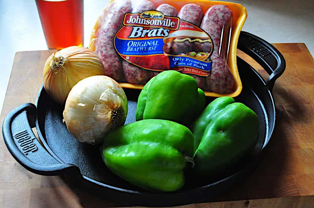 Ingredients: A grill safe pan, brats, onions, peppers, and a beer