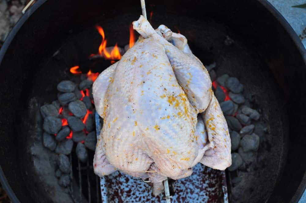 Turkey on the rotisserie spit over the charcoal grill
