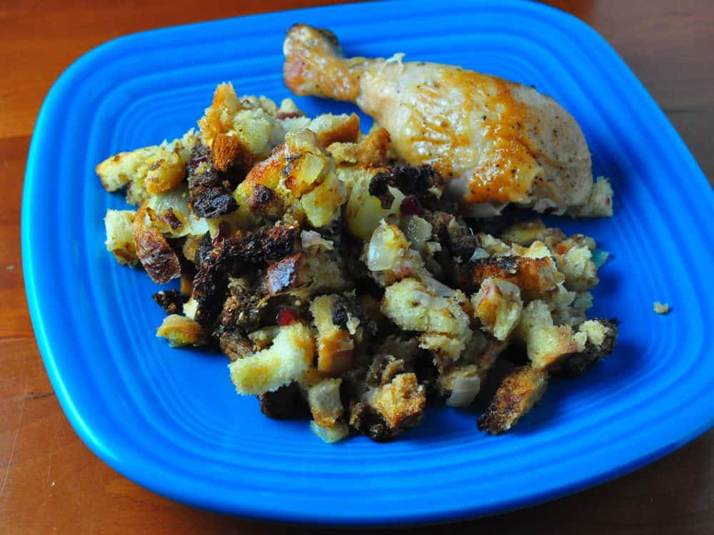 A plate of stuffing and a chicken leg