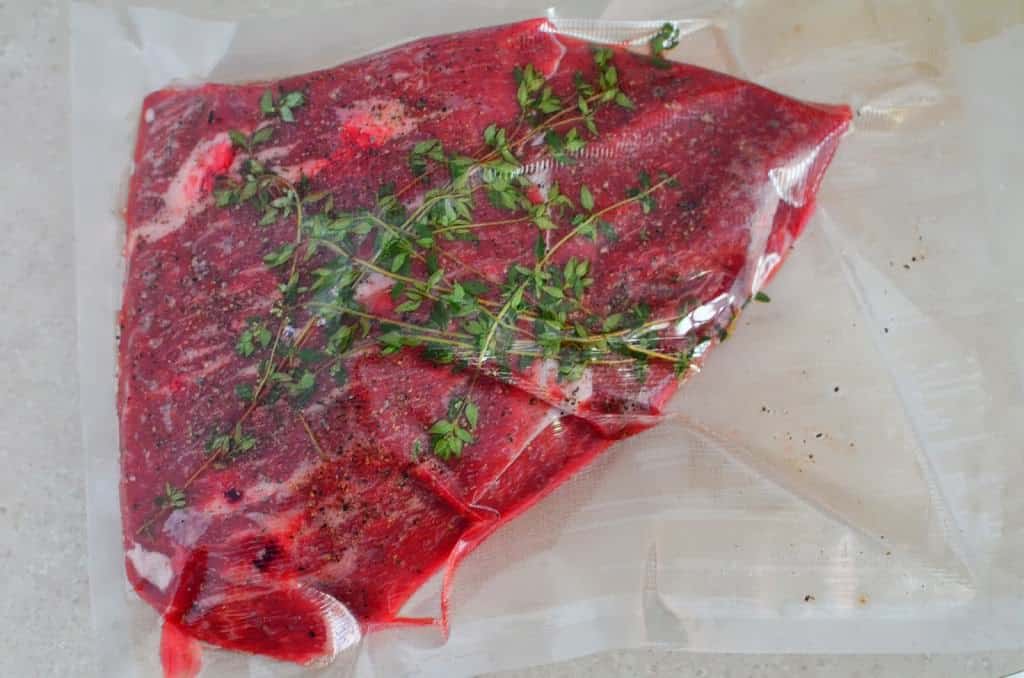 Top sirloin roast vacuum sealed with thyme and garlic