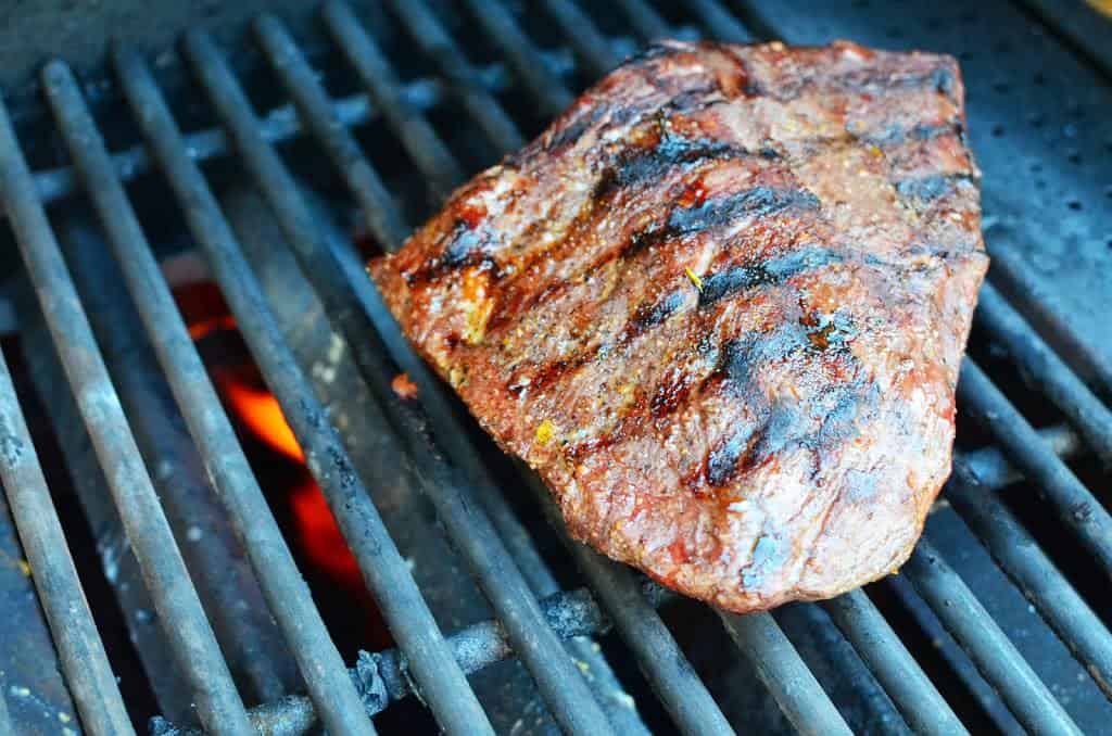 Top sirloin roast searing on the grill