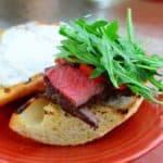 sous vide sirloin on grilled bread with horseradish sauce and arugula