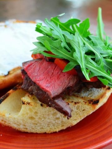 sous vide sirloin on grilled bread with horseradish sauce and arugula