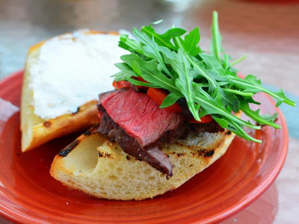 sous vide sirloin on grilled bread with horseradish sauce and arugula