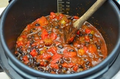 Stirring in the beans and tomatoes