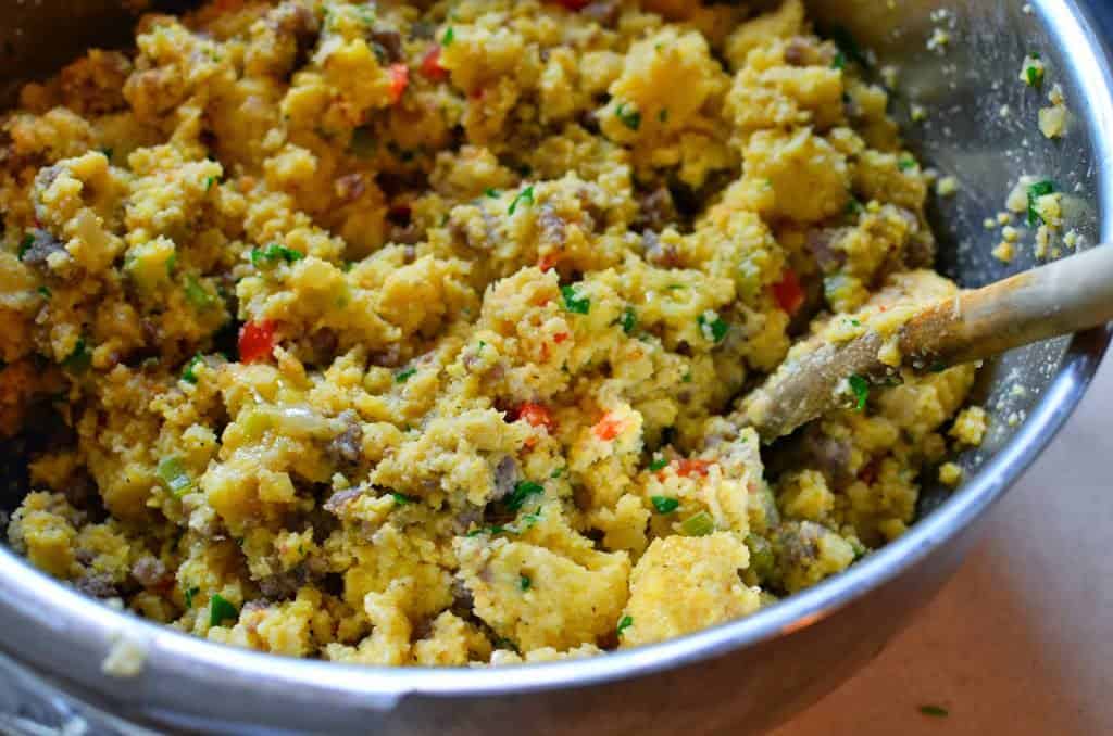 Mixing ingredients for a bowl of cornbread stuffing