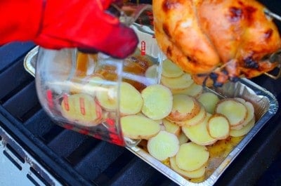 Adding potatoes to the drip pan