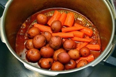 Potatoes and carrots in steamer basket