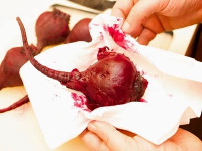 Peeling the cooked beets