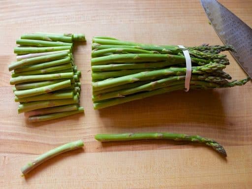 Trimming the woody ends of the asparagus spears | DadCooksDinner.com