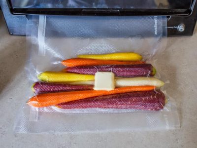 Carrots vacuum sealed with a pat of butter