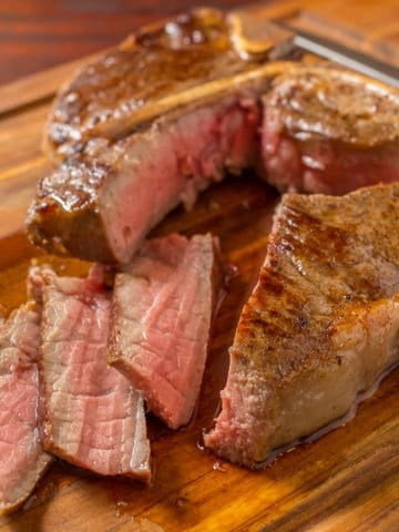Porterhouse steak with slices on a cutting board
