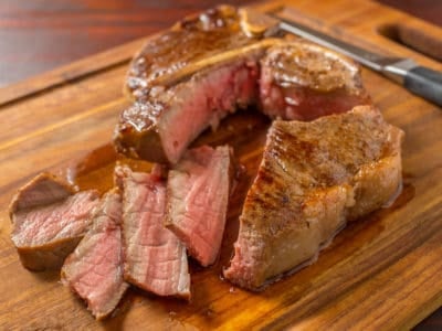 Porterhouse steak with slices on a cutting board