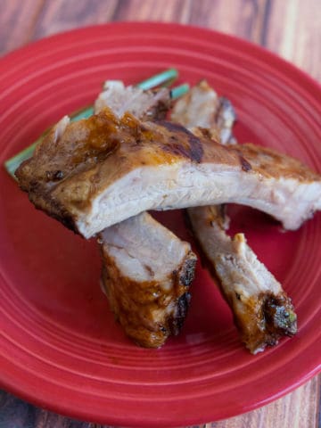 A pile of cooked and sauced sous vide baby back ribs