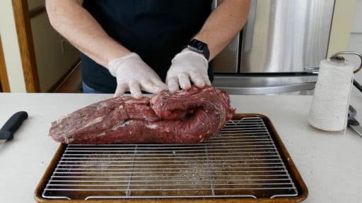 Folding the roast to see where to cut it