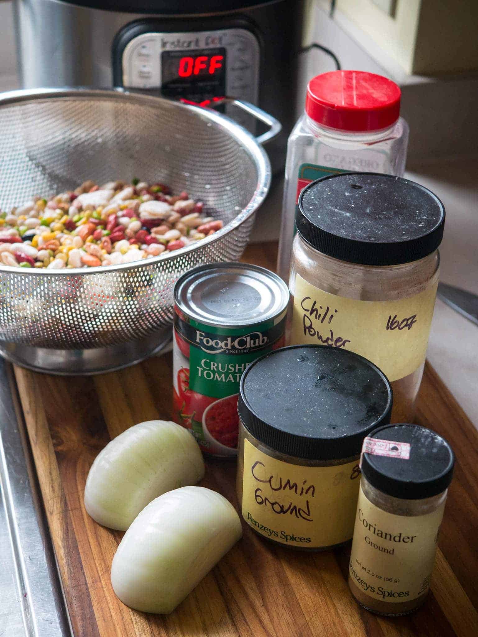 Ingredients for 15 bean chili on a cutting board