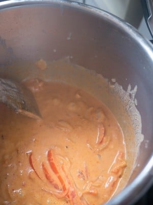 Frying the curry paste and coconut cream