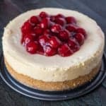 An Instant Pot New York cheesecake topped with cherries