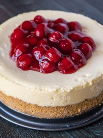 An Instant Pot New York cheesecake topped with cherries