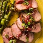 Slices of grilled pork tenderloin with gochujang and green onions