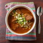 A bowl of Texas red chili sprinkled with green onions