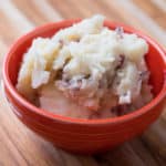 A bowl of smashed red skin potatoes