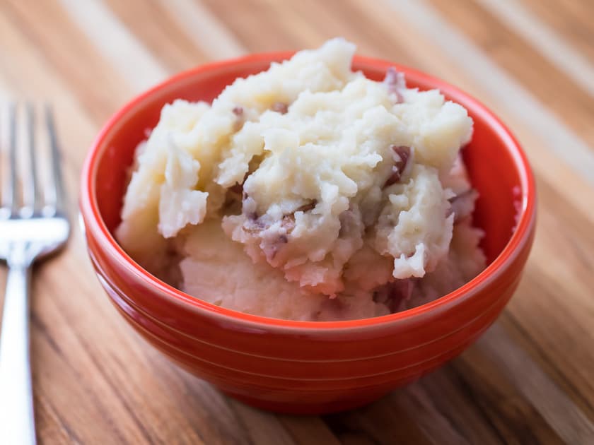A bowl of smashed red skin potatoes