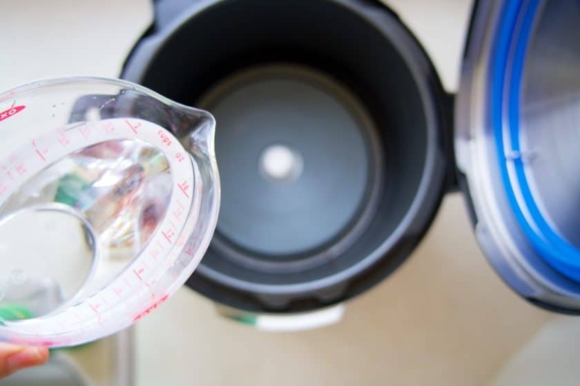 Water poised over an Instant Pot cooker base without the liner