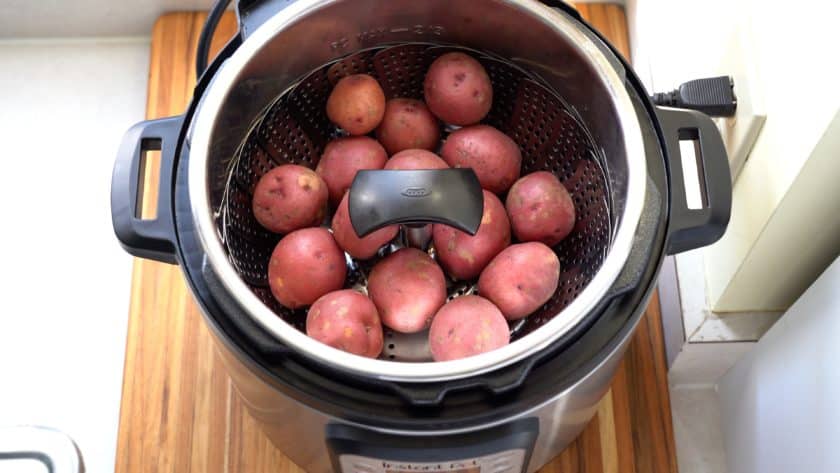 Baby potatoes in a steamer basket in an Instant Pot