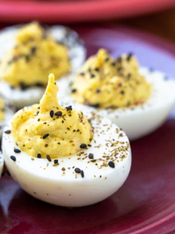 Wasabi deviled eggs on a purple plate