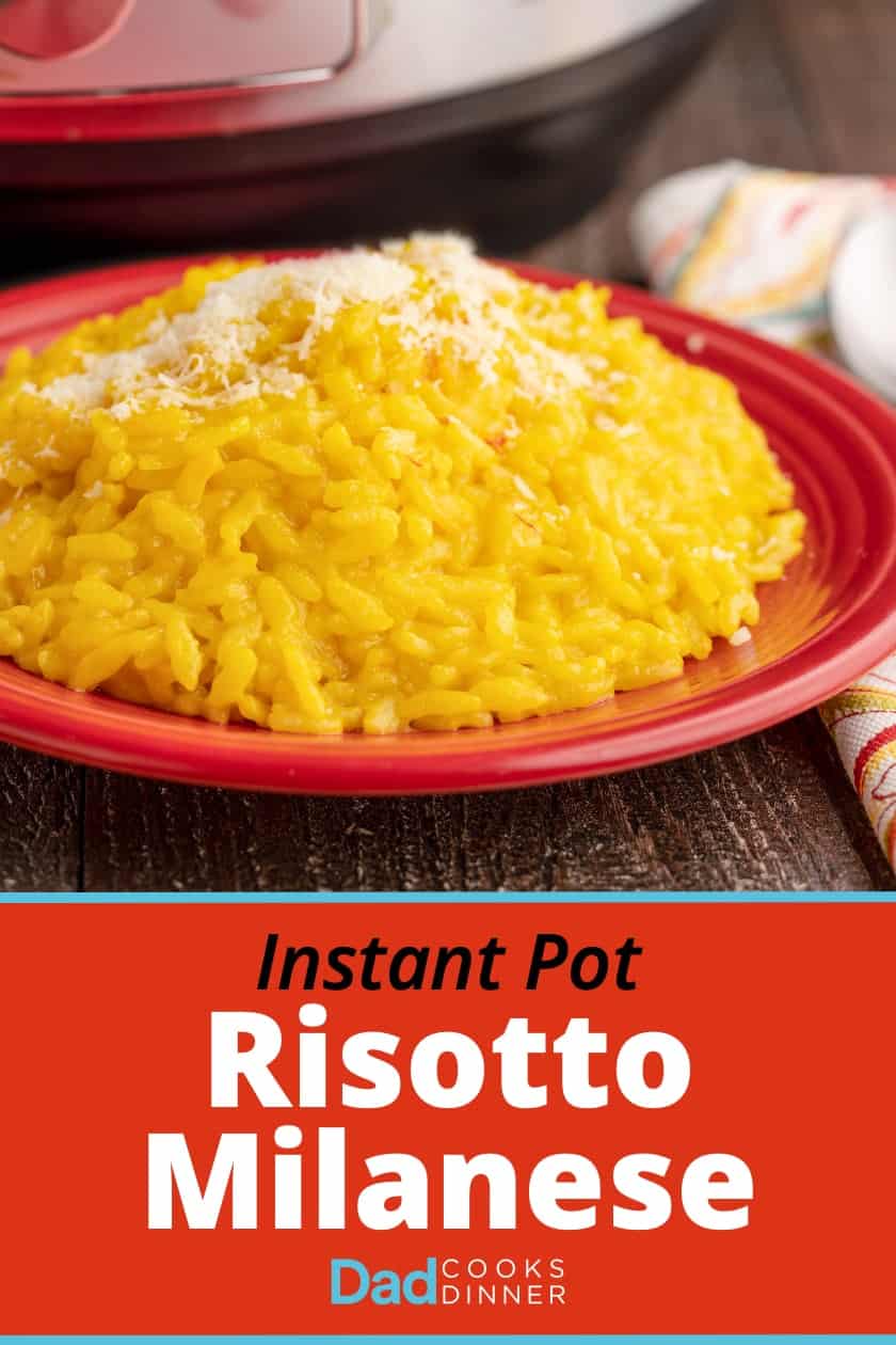 A red plate of bright yellow risotto Milanese sprinkled with grated cheese, with a napkin, spoon, and instant pot in the background, and the text Instant Pot Risotto Milanese | DadCooksDinner.com
