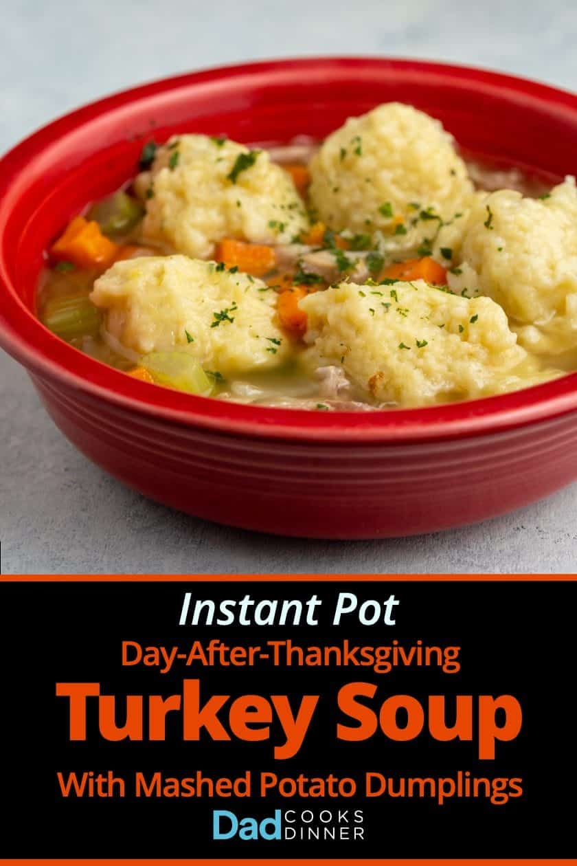 A red bowl of Turkey Soup with Mashed Potato Dumplings on a white background