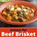 A bowl of beef brisket soup with carrots, green onions, and thyme, in an orange bowl on a slate-gray background