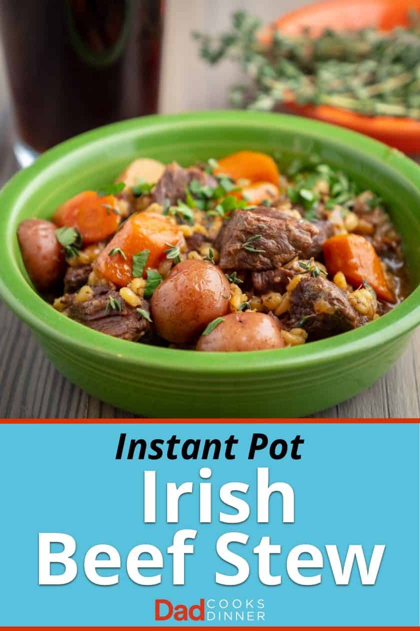 A green bowl full of beef stew with potatoes, carrots and barley; sprinkled with parsley and thyme leaves, with a glass of stout and a bowl of thyme in the background