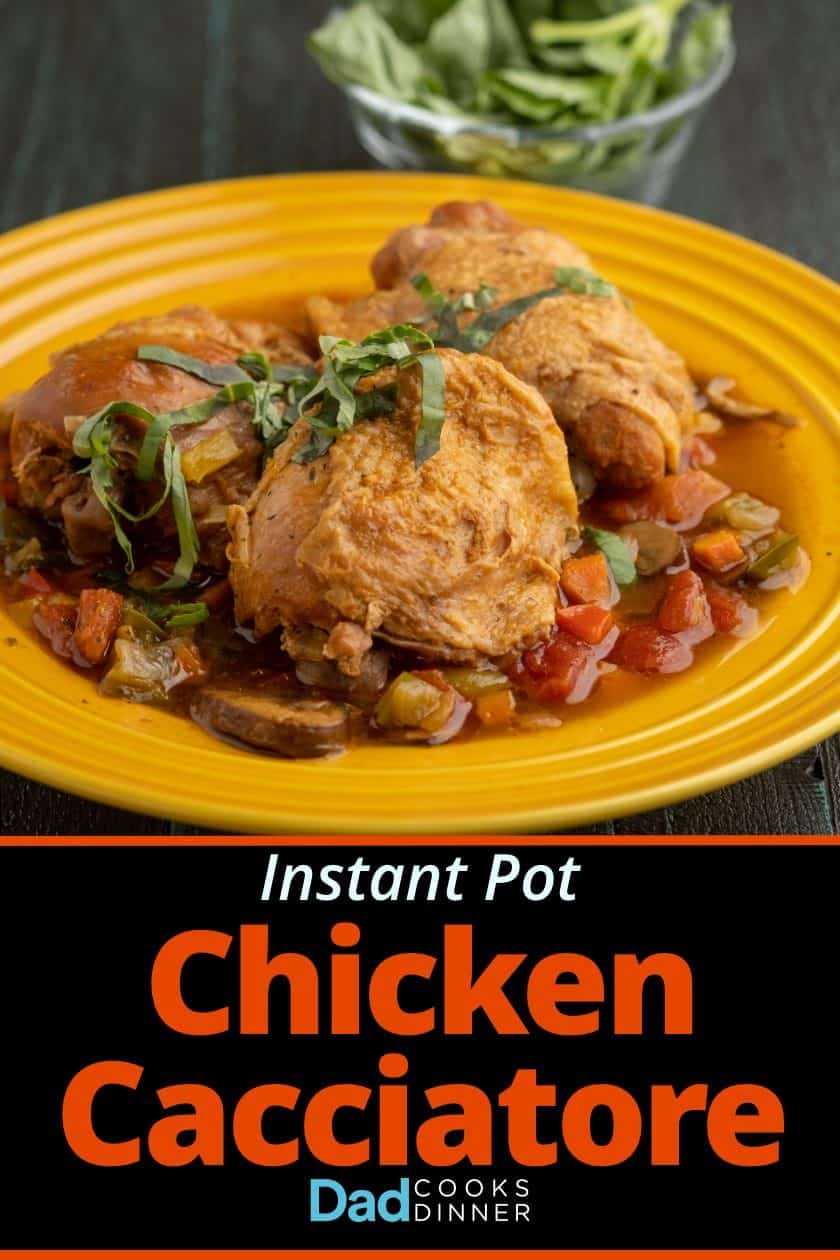 Chicken cacciatore: Chicken thighs, sprinkled with basil, on a bed of cooked vegetables and cooking liquid, on a yellow plate, with a bowl of basil in the background.