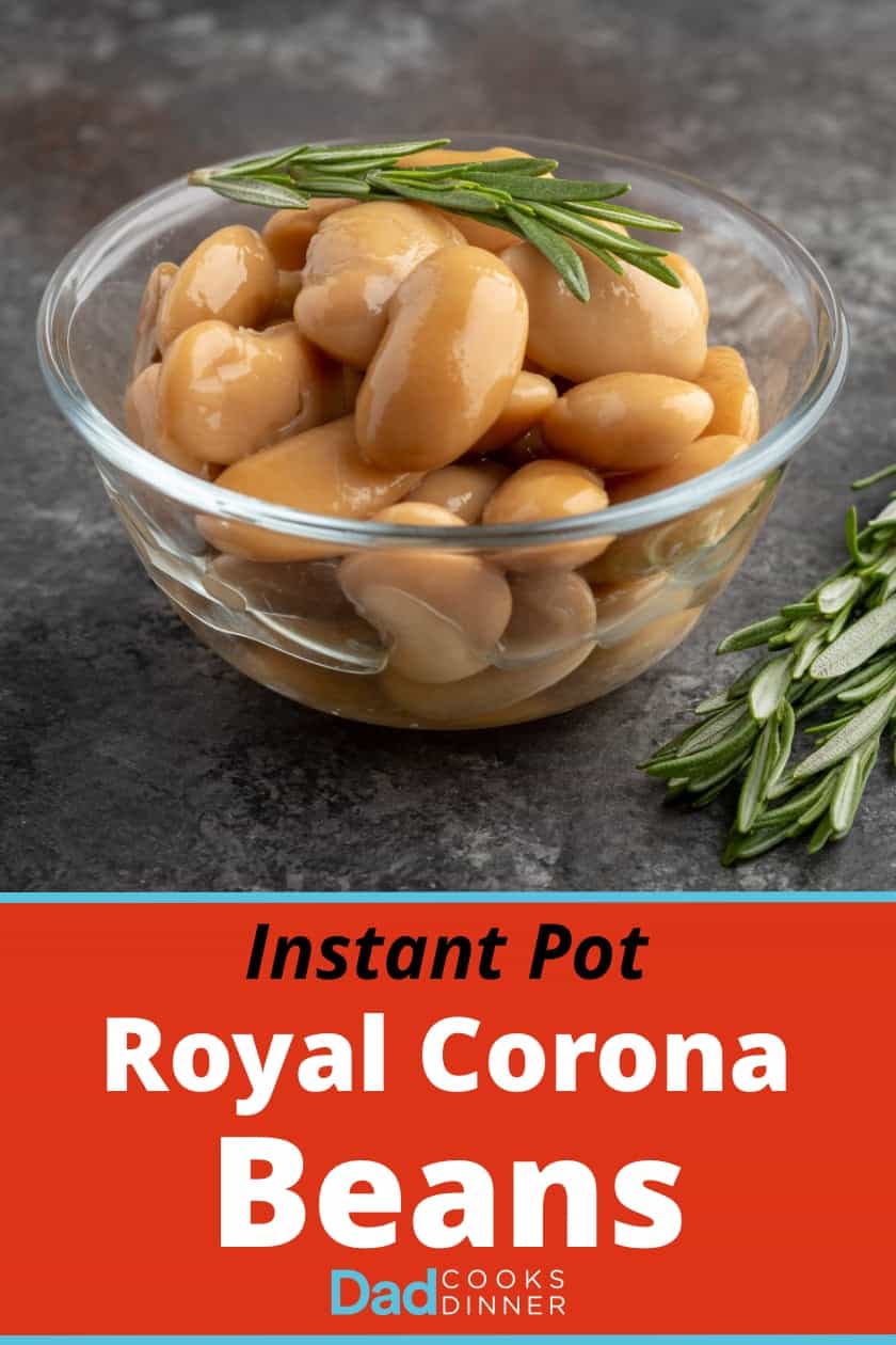 A bowl of cooked royal corona beans with a sprig of rosemary on top and on the table next to them