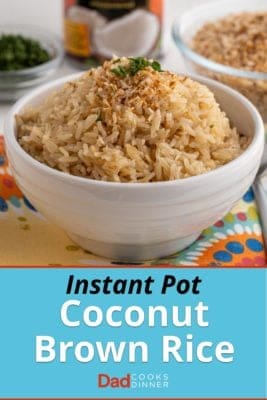 A bowl of brown coconut rice, sprinkled with toasted coconut flakes and a little minced cilantro
