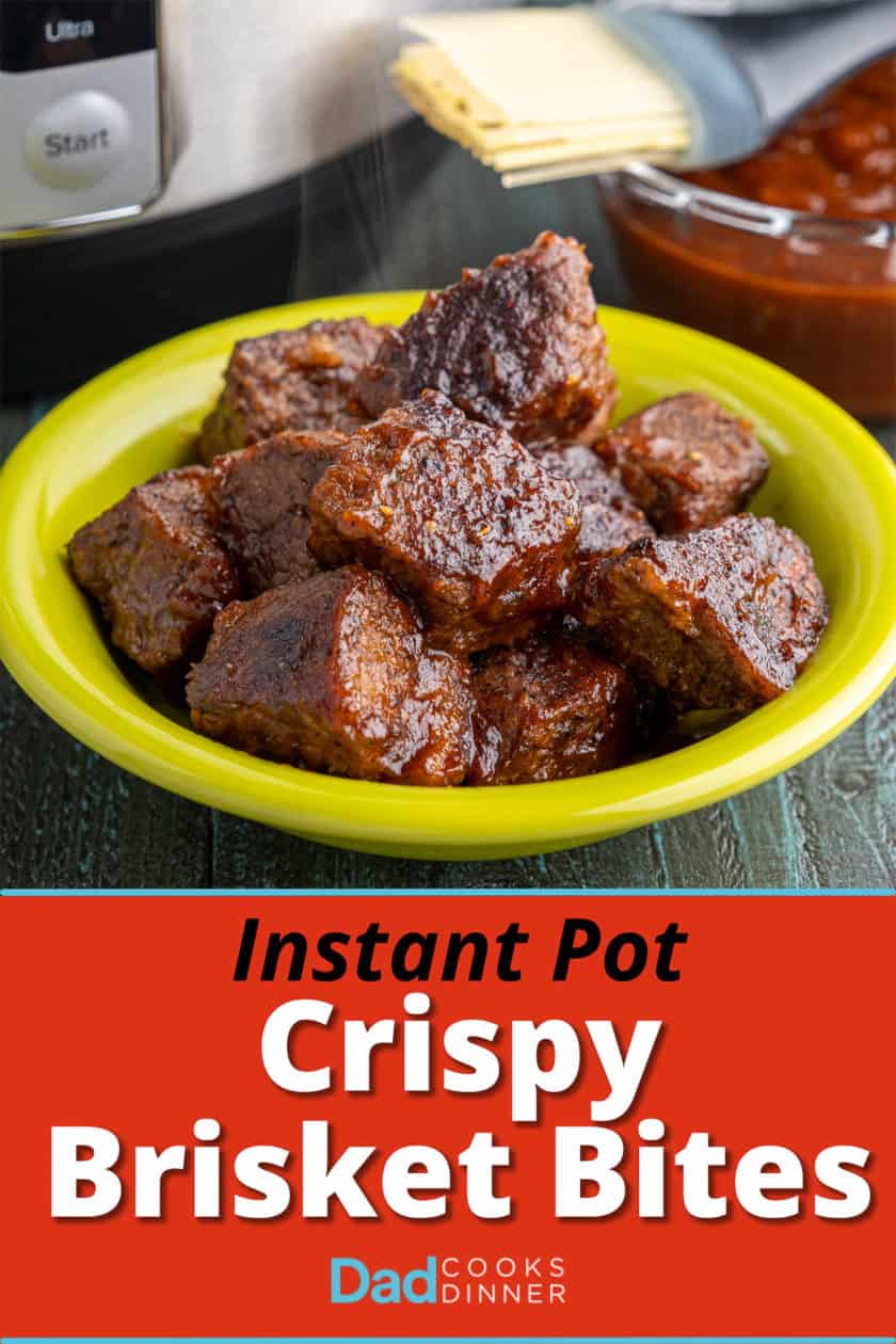 A bowl full of cooked brisket cubes, glazed with barbecue sauce, with an Instant Pot and a bowl of barbecue sauce in the background