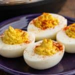 Deviled eggs, sprinkled with paprika, on a plate