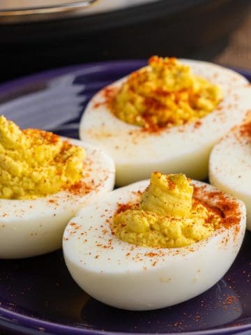 Deviled eggs, sprinkled with paprika, on a plate