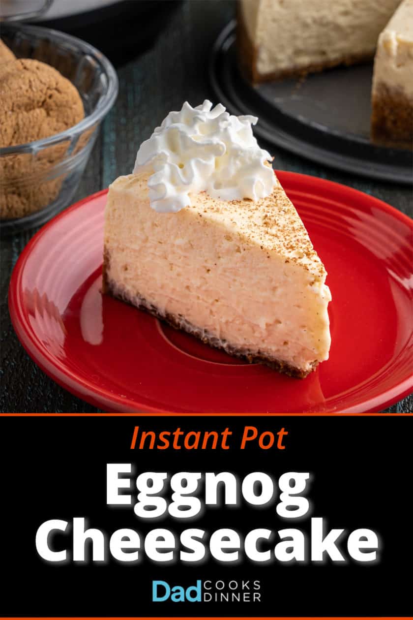 A slice of eggnog cheesecake on a red plate, with ginger snaps, an Instant Pot, and the rest of the cheesecake in the background