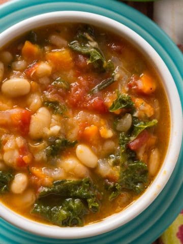 A bowl of Tuscan bean soup on a colorful plate