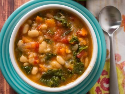 A bowl of Tuscan bean soup on a colorful plate