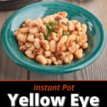 A bowl of cooked yellow eye beans on a wood table with an Instant Pot and some uncooked beans in the background