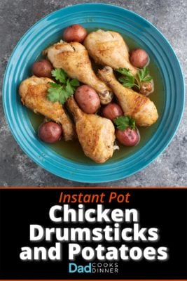 A bowl of cooked chicken drumsticks and baby red potatoes, with parsley leaves